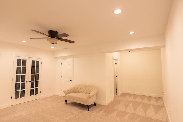 sitting room featuring light carpet, ceiling fan, and french doors