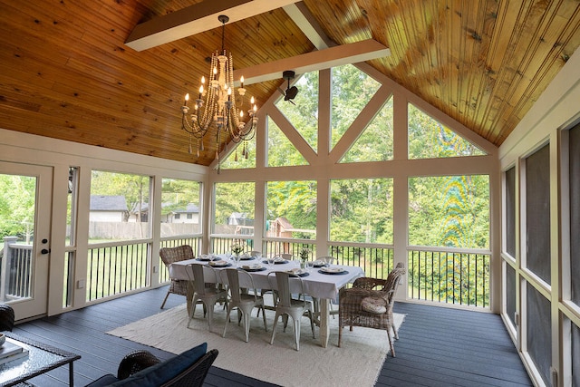 sunroom / solarium with lofted ceiling with beams and a chandelier