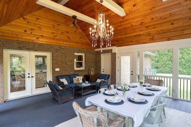 dining area featuring brick wall, high vaulted ceiling, and a wealth of natural light