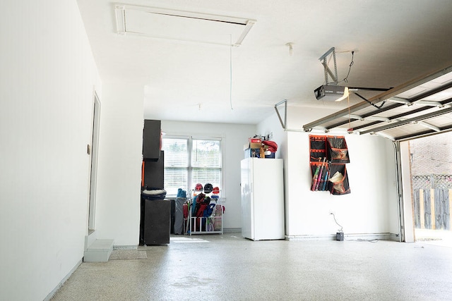 garage featuring a garage door opener and white fridge