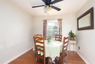 dining space with dark hardwood / wood-style flooring and ceiling fan