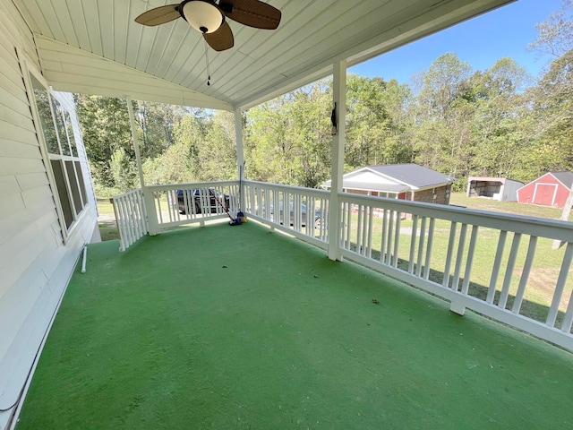 view of patio with ceiling fan and a storage shed