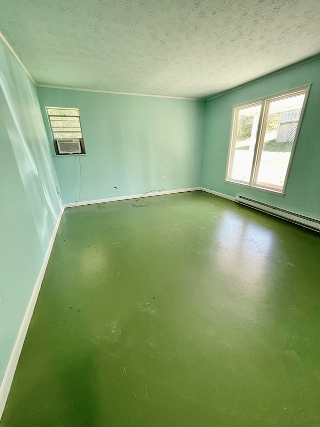 spare room featuring cooling unit, a baseboard radiator, a textured ceiling, and concrete floors