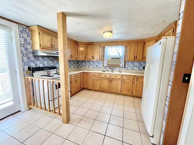 kitchen with white fridge with ice dispenser, stove, sink, and tasteful backsplash