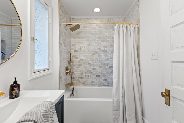 bathroom featuring vanity, shower / bathtub combination with curtain, and ornamental molding