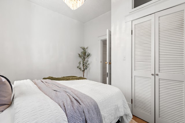 bedroom featuring hardwood / wood-style floors and a closet