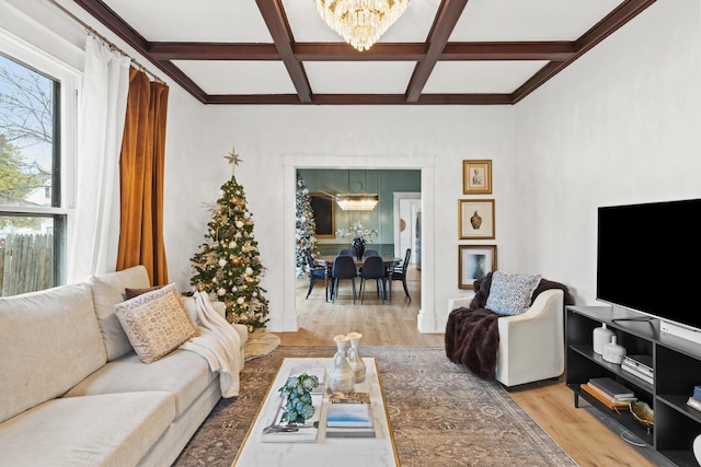 living room with a chandelier, beamed ceiling, light hardwood / wood-style floors, and coffered ceiling