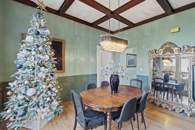 dining space with beamed ceiling, an inviting chandelier, light wood-type flooring, and coffered ceiling