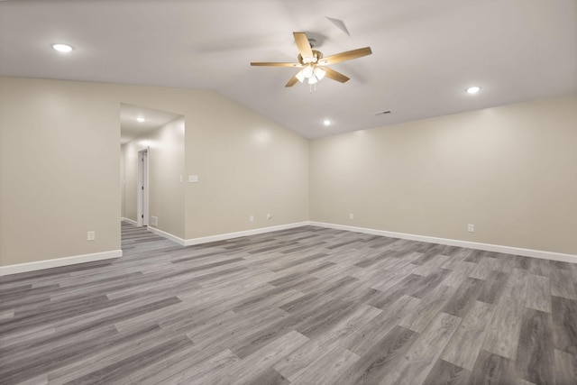 empty room with hardwood / wood-style floors, lofted ceiling, and ceiling fan