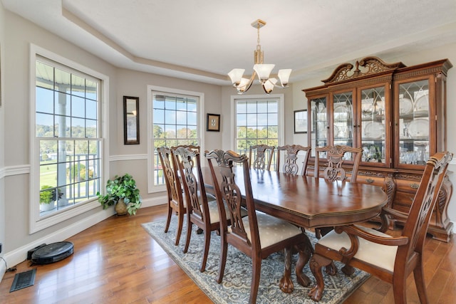 dining space featuring a notable chandelier and light hardwood / wood-style flooring