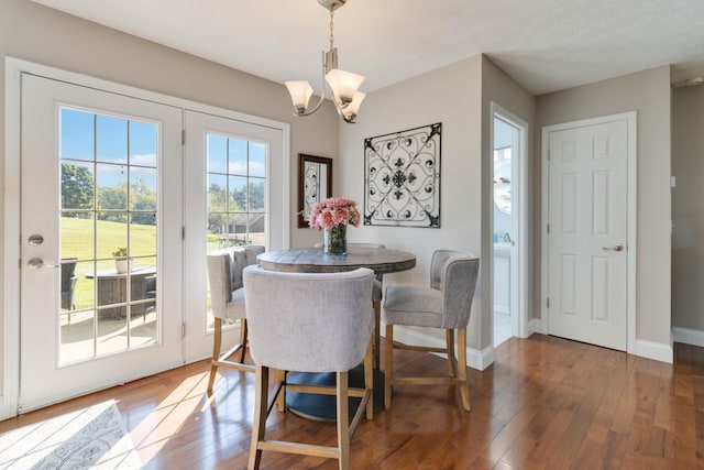 dining space featuring a chandelier and dark wood-type flooring