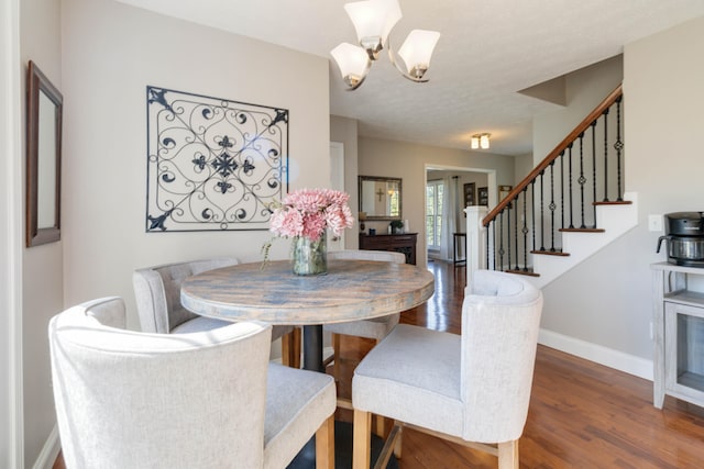 dining area with an inviting chandelier and dark wood-type flooring