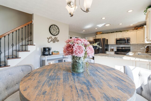 dining room with a chandelier and sink