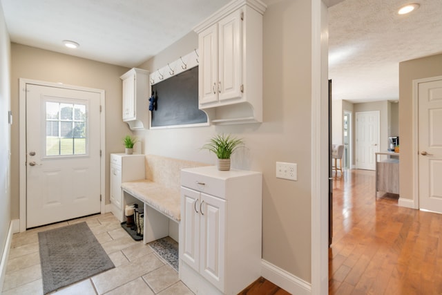 mudroom with light hardwood / wood-style floors