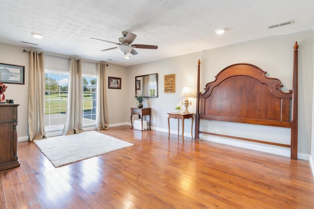 bedroom with ceiling fan and hardwood / wood-style flooring