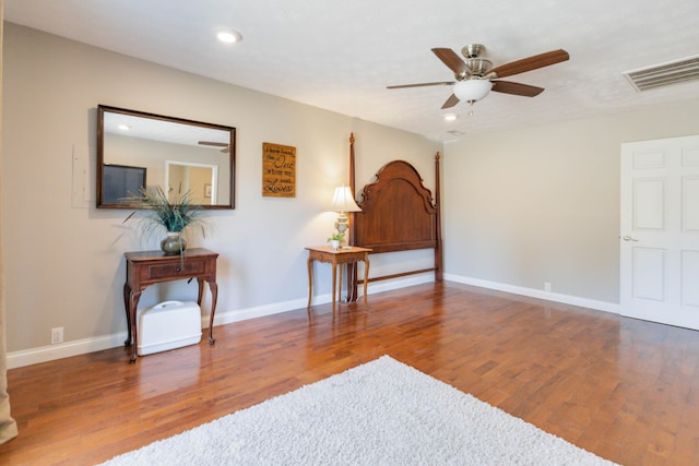 interior space with ceiling fan and dark hardwood / wood-style flooring