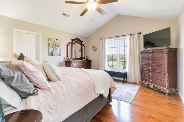 bedroom with wood-type flooring, lofted ceiling, and ceiling fan