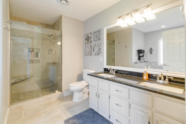 bathroom featuring vanity, toilet, tile patterned floors, and a shower with door