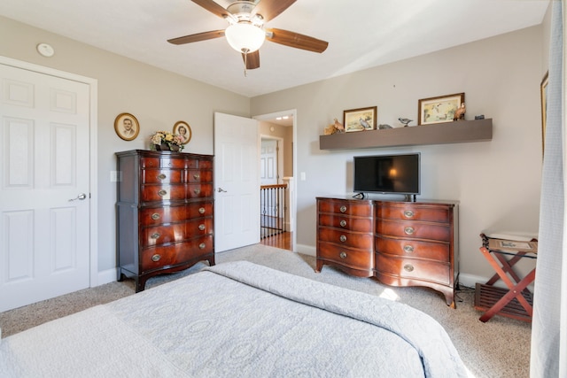 bedroom with ceiling fan and light colored carpet