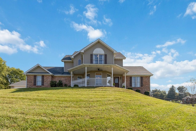 view of front of home with a porch and a front yard