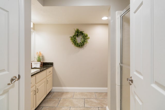 bathroom featuring vanity, tile patterned flooring, and an enclosed shower