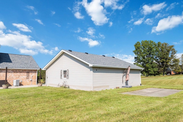 back of property with a lawn, a patio, and central AC unit