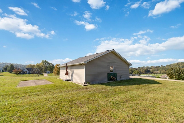 view of property exterior with a yard