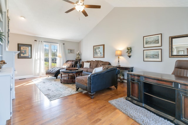 living room with high vaulted ceiling, a high end fireplace, light hardwood / wood-style floors, and ceiling fan