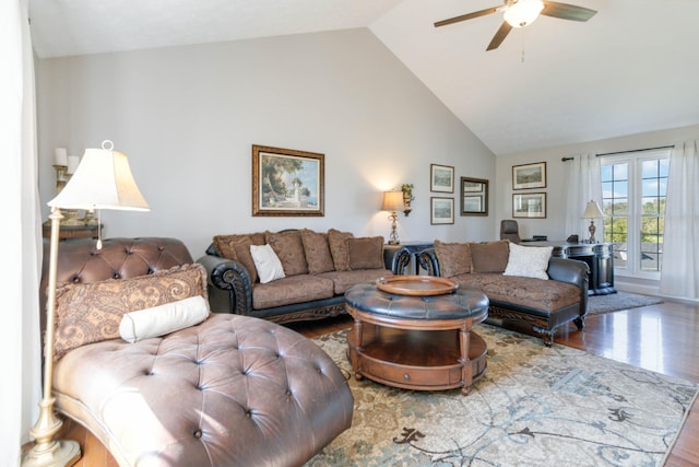 living room with hardwood / wood-style floors, ceiling fan, and high vaulted ceiling