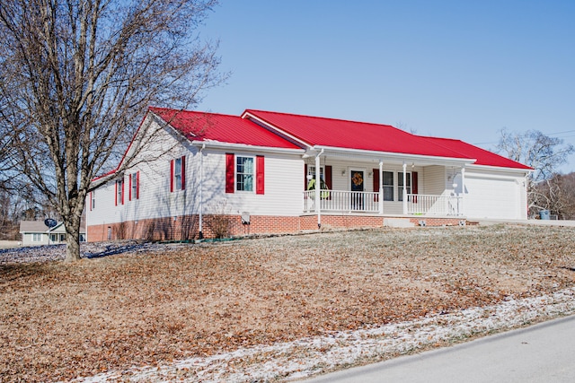 single story home featuring a porch and a garage