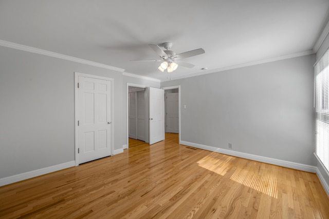 unfurnished bedroom featuring multiple windows, crown molding, light hardwood / wood-style floors, and ceiling fan