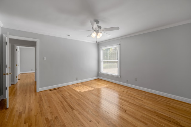 spare room with ornamental molding, light wood-type flooring, and ceiling fan