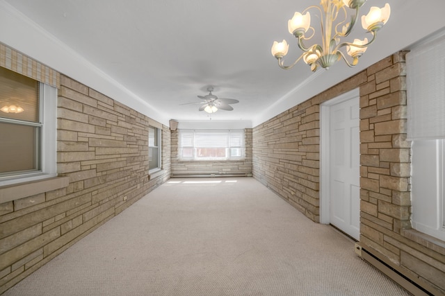 unfurnished living room featuring light carpet, a baseboard radiator, ceiling fan with notable chandelier, and crown molding