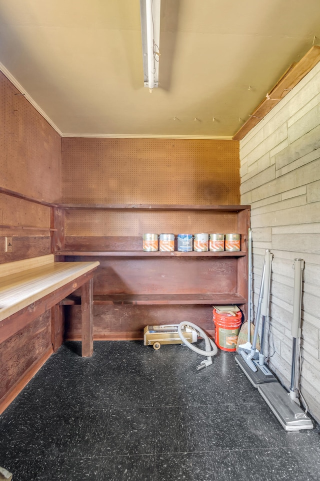 miscellaneous room featuring wooden walls and ornamental molding