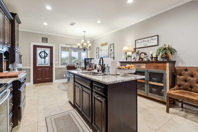 kitchen with light stone counters, sink, a kitchen island with sink, a chandelier, and crown molding