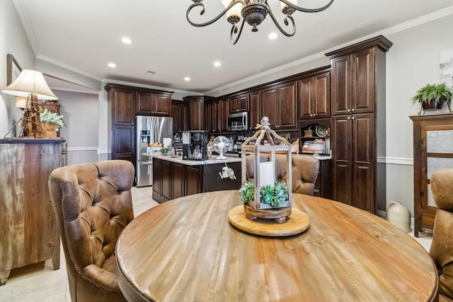 tiled dining area featuring crown molding and a chandelier