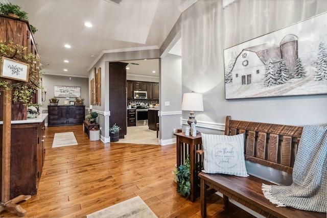 sitting room with light hardwood / wood-style flooring and ornamental molding