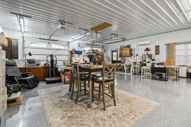 garage with a garage door opener and a wall unit AC