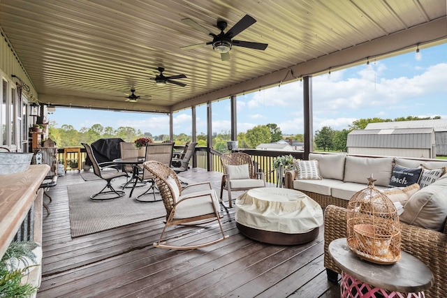 wooden terrace featuring an outdoor hangout area and ceiling fan