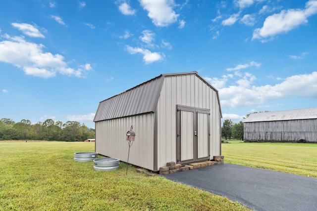 view of outbuilding featuring a lawn