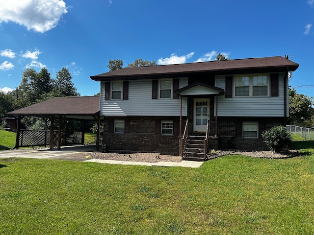 split foyer home featuring brick siding, entry steps, a carport, driveway, and a front lawn