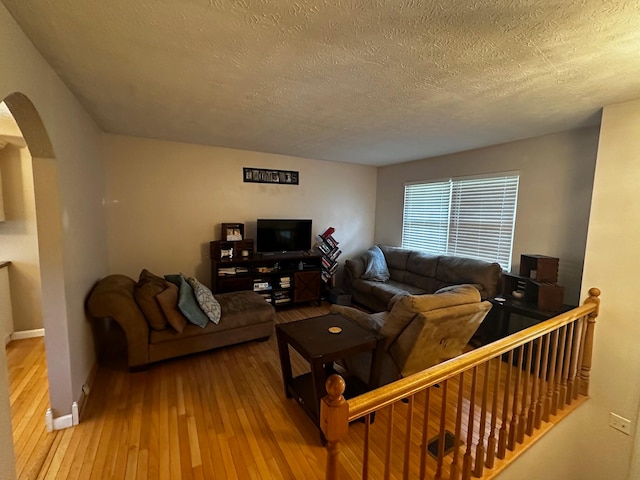 living room featuring a textured ceiling and hardwood / wood-style flooring