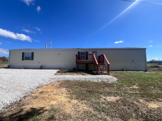 rear view of property featuring a deck