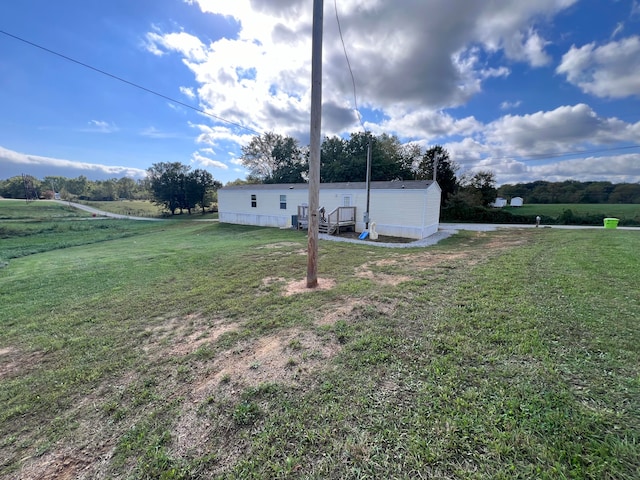 view of yard with a rural view