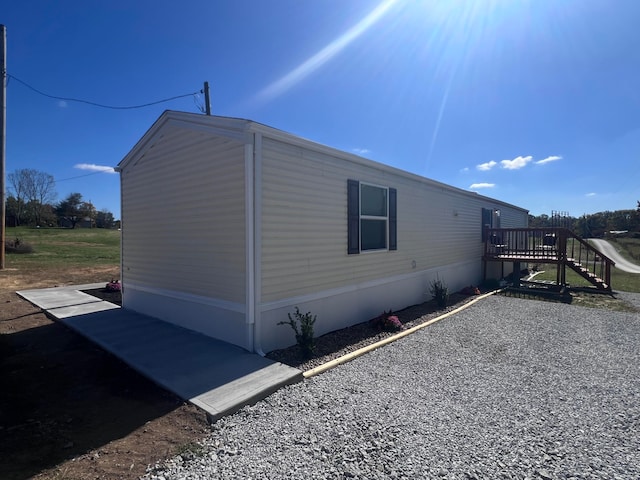 view of property exterior with a deck