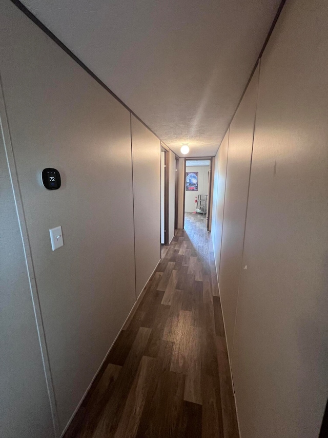 corridor with dark hardwood / wood-style floors