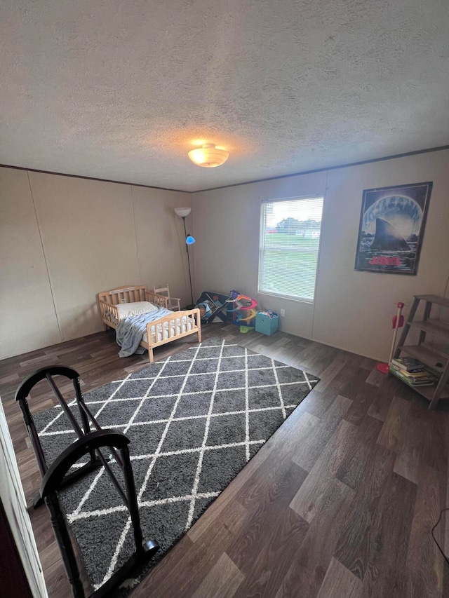 unfurnished bedroom with a textured ceiling and wood-type flooring