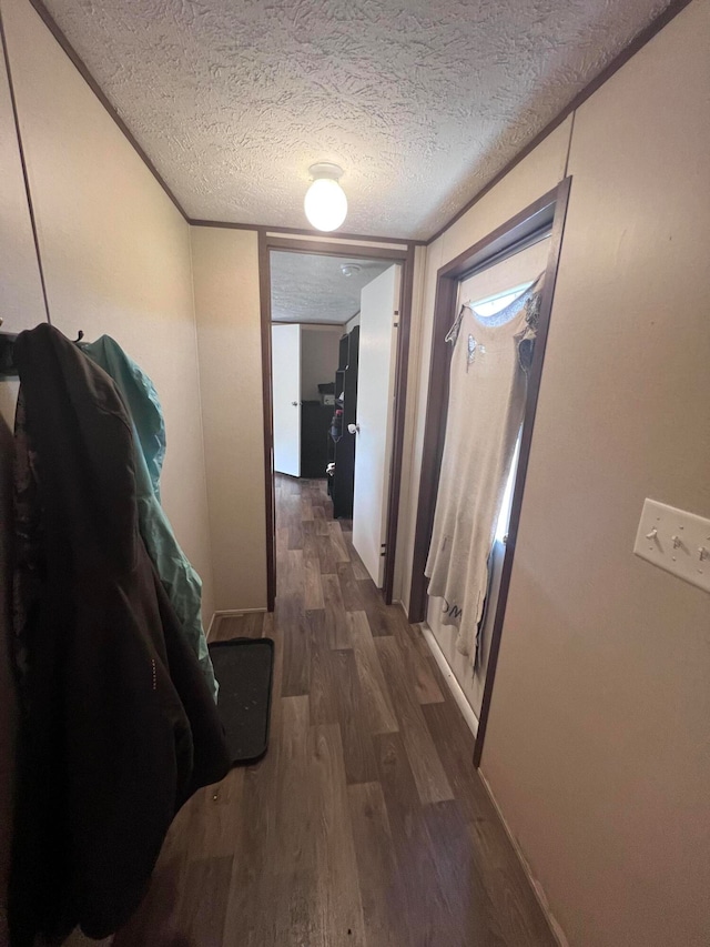 hallway featuring a textured ceiling and dark hardwood / wood-style floors