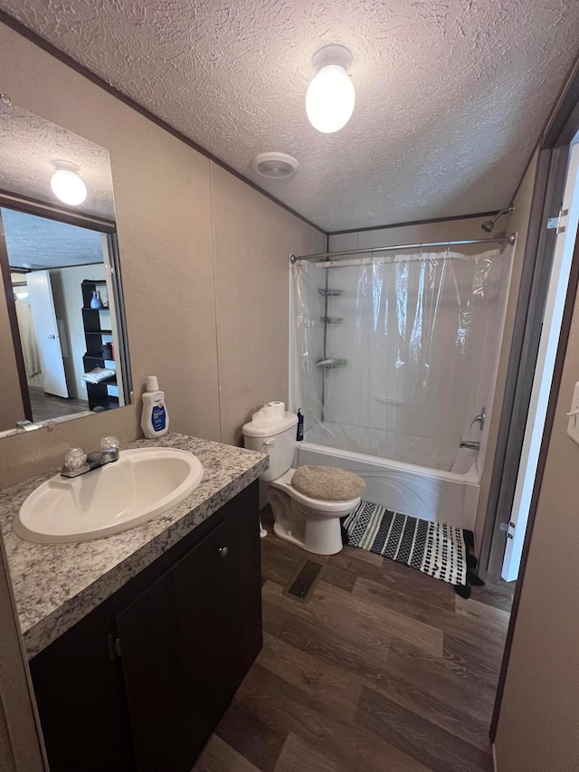 full bathroom with shower / bath combination with curtain, toilet, a textured ceiling, and vanity