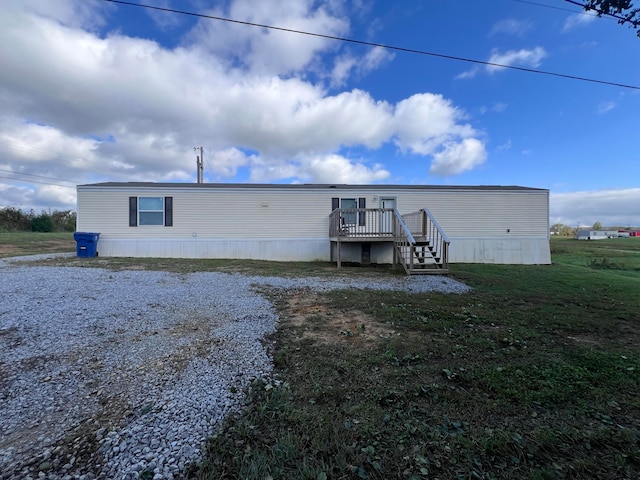 rear view of property featuring a wooden deck